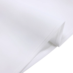 Close-up of white dress showing double-needle stitching and premium knit texture