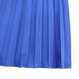 Macro shot of bright blue pleated fabric detail with professional hem stitch edge