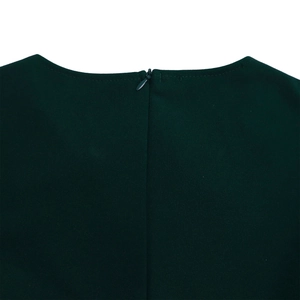 Detail view of the deep green dress back featuring a hidden zipper and premium stitching