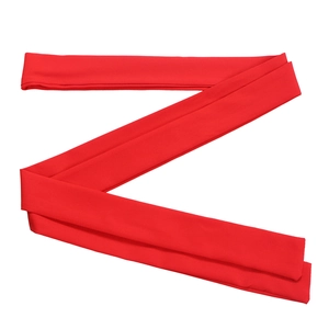 Detailed view of folded bright red elastic fabric headband with smooth textile texture