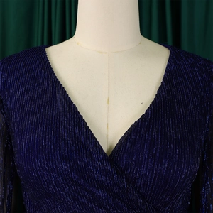 Detail of elegant navy V-neck dress featuring metallic pleated texture and long sleeves