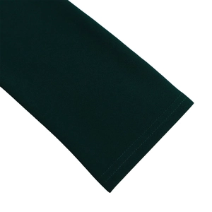 Detail of dark green dress showing high-quality knitted fabric and precise double stitching