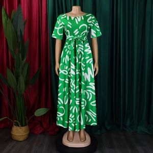 Detail of green African print maxi dress with white abstract patterns and belted waist