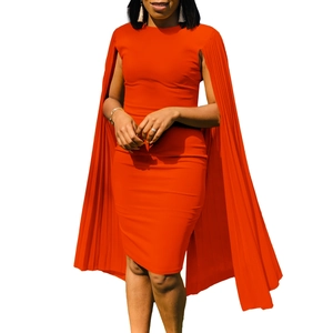 Detail of elegant orange bodycon dress featuring sophisticated pleated cape sleeves