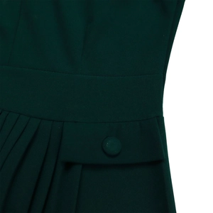 Close-up of pleated dark green fabric featuring a matching fabric-covered button detail