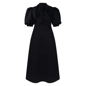 Detail of elegant black puff sleeve dress with a large pussy-bow tie and cinched waist