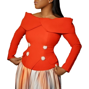 Detail of off-shoulder orange top with elegant pearl rhinestone flower buttons