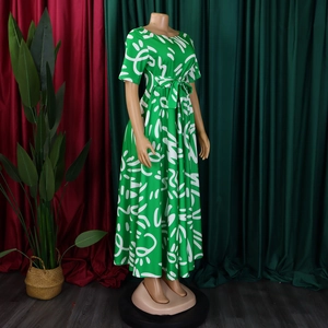 Detail of green short-sleeve maxi dress featuring white abstract print and drawstring waist