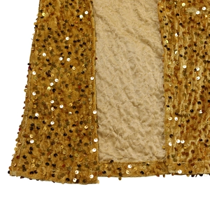 Macro detail of mustard gold sequins on luxury velvet fabric for elegant dress