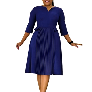Detail view of navy blue dress with V-neckline and pleated front center structure