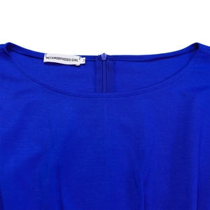 Close-up of royal blue jumpsuit neckline featuring hidden back zipper and brand label