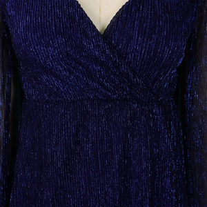 Detail of V-neck wrap dress with shimmering dark blue pleated metallic glitter fabric