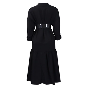 Back view of black long sleeve midi dress featuring a transparent waist belt and ruffle hem