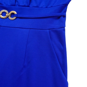 Close-up of royal blue jumpsuit waist with golden rhinestone-studded ring belt detail