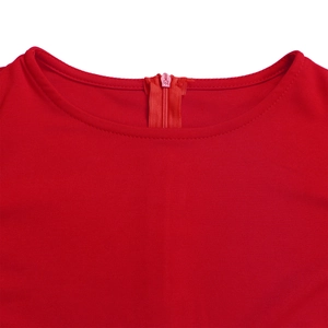Detailed view of the red dress showing the high-quality back zipper and pleated fabric texture