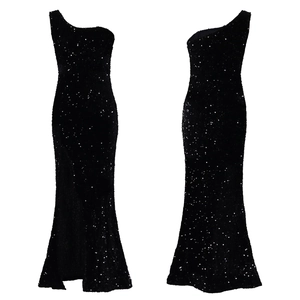 Detail of a black sequined one-shoulder evening gown with a high slit side and slim fit