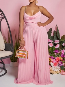 Elegant pink halter jumpsuit with gold chain straps and pleated wide-leg trousers