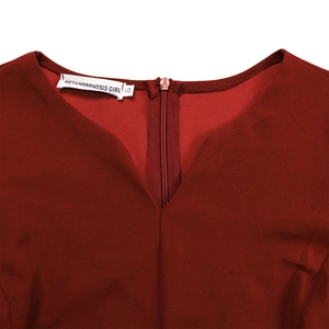 Detail view of burgundy V-neckline with pleated fabric and hidden back zipper