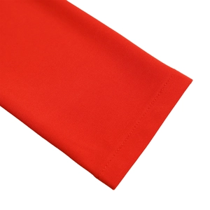 Detailed close-up showing the fine knitted texture and precise stitching of the red fabric