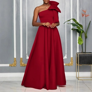 Detail of the oversized bow decoration on a burgundy one-shoulder satin evening gown