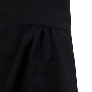 Close-up of black shirt dress featuring gathered waist details and pleated fabric texture