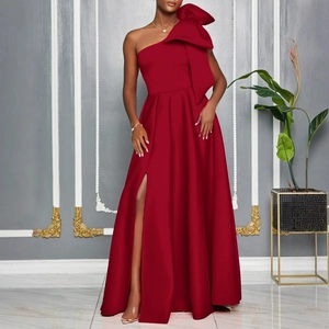 Detail shot of a dark red one-shoulder evening gown with a large bow and side high slit