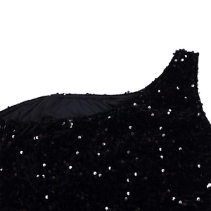 Detailed macro view of black sequined velvet fabric with high-density circular sequins