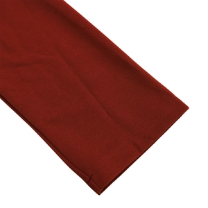 Close-up of deep red dress showing detailed double-stitched hem and fine fabric texture
