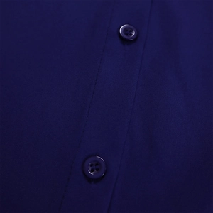 Detailed close-up of navy blue dress buttons and fine plain weave fabric texture