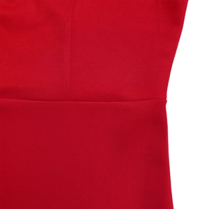 Macro shot of red pleated dress fabric showing high-quality stitching and smooth texture