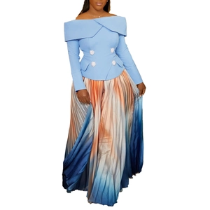 Detail of off-shoulder light blue top with silver buttons and ombre pleated maxi skirt