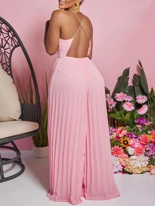 Pink pleated halter neck jumpsuit with backless design and gold chain straps