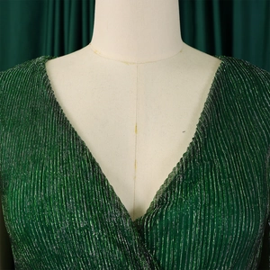 Detail of elegant V-neckline dress featuring dark green pleated metallic fabric texture