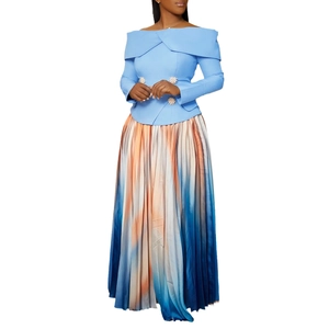Detail of elegant off-shoulder top with pearl buckle and ombre pleated long skirt
