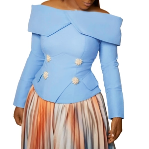 Detail of light blue off-shoulder top with pearl buttons and pleated gradient skirt