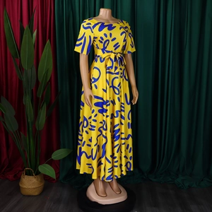 Detail of yellow maxi dress featuring blue abstract print and waist tie-up bow