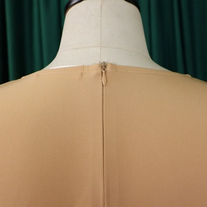 Macro shot of the discreet invisible zipper and woven texture on a khaki dress