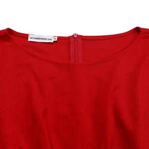 Close-up of a red jumpsuit showing the round neckline, invisible back zipper, and size label