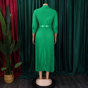 Back view of green pleated midi dress with waist belt and turn-down collar on mannequin