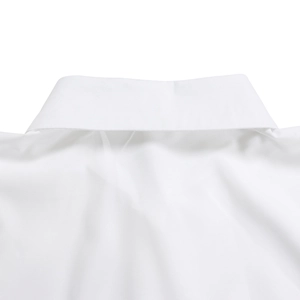 Detailed close-up of a white high-density cotton shirt featuring a sharp lapel collar