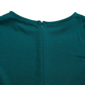 Detail view of the invisible back zipper and round neckline on a teal party dress