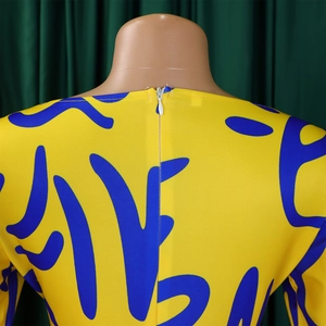 Detail of invisible back zipper on yellow dress with blue abstract geometric patterns