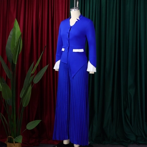 Detail of royal blue two-piece set featuring pleated bell sleeves and wide-leg trousers
