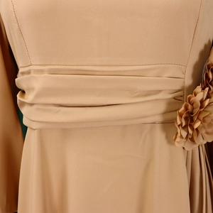 Detail of elegant khaki A-line dress featuring pleated waist and 3D floral decoration