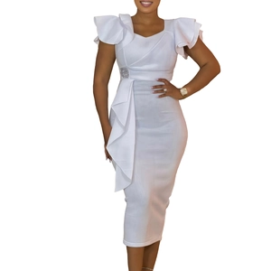 Detail of white ruffle dress featuring square rhinestone buckle and elegant pleats