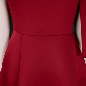 Detailed view of dark red evening dress with vertical texture and pleated waistline