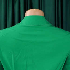 Detail view of the v-neckline and high-quality back stitching on this green dress