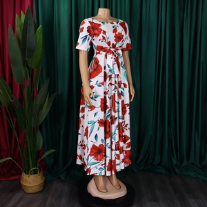 Détail du nœud à la taille et de l'imprimé fleuri sur la robe longue grande taille