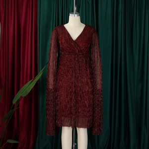Detail of elegant V-neck wine red pleated dress with unique cape sleeves on a mannequin