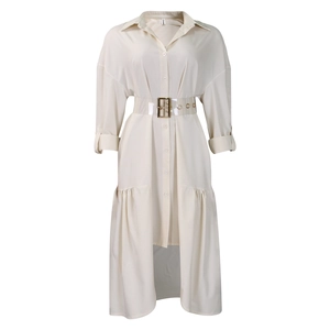 Detail of beige shirt dress with transparent belt and ruffled hemline on plain background